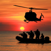 Navy seal silhouettes  on sunrise